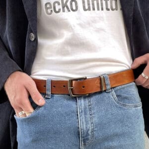 person white t shirt wearing a tan premium leather belt