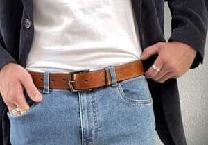 man hands on hips with leather belt
